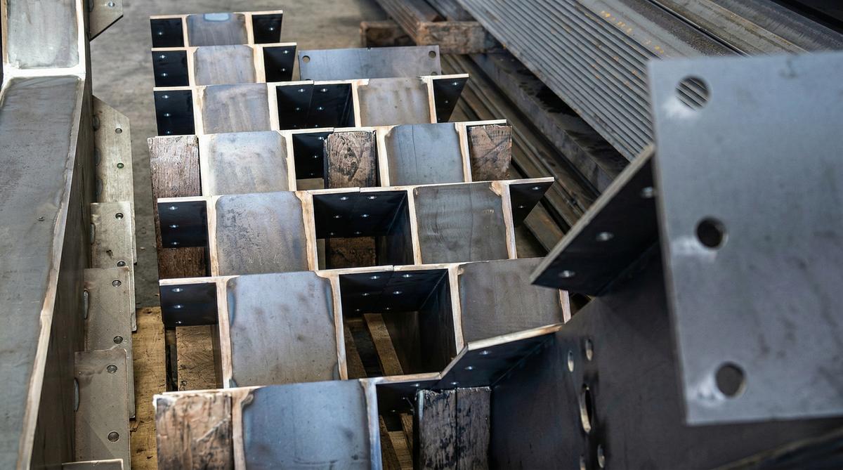 Rows of welded steel channel brackets on a pallet, ready to ship